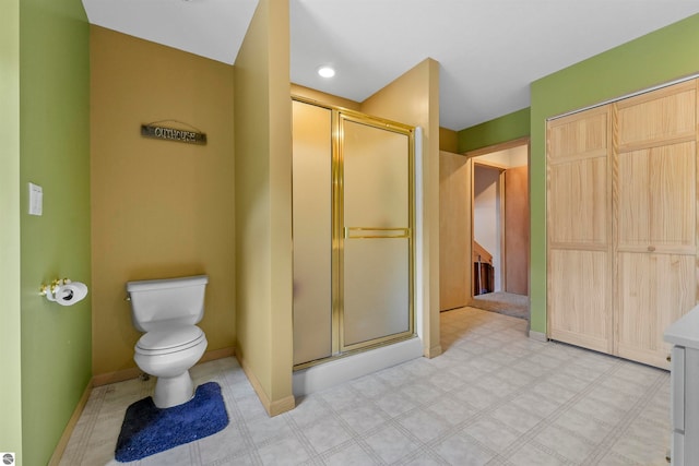 bathroom with vanity, toilet, and an enclosed shower