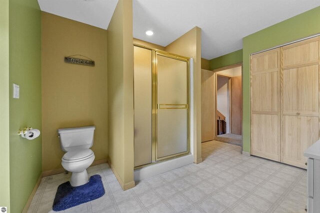 7504 W Dakota Trl, Lake City, MI 49663 - full bath with toilet, a stall shower, baseboards, and tile patterned floors