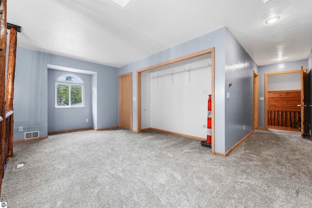 unfurnished bedroom with a closet and carpet