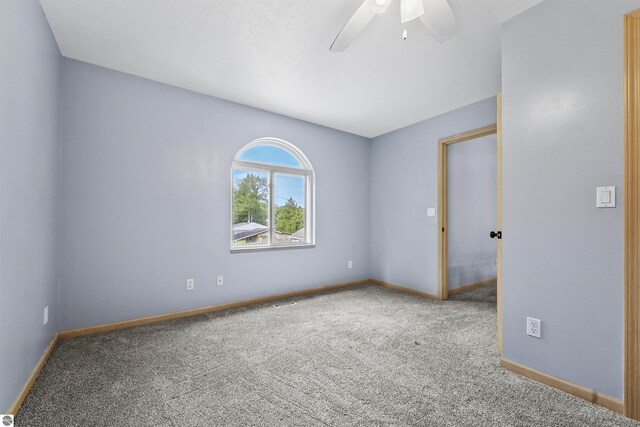 7504 W Dakota Trl, Lake City, MI 49663 - carpeted spare room featuring baseboards and ceiling fan