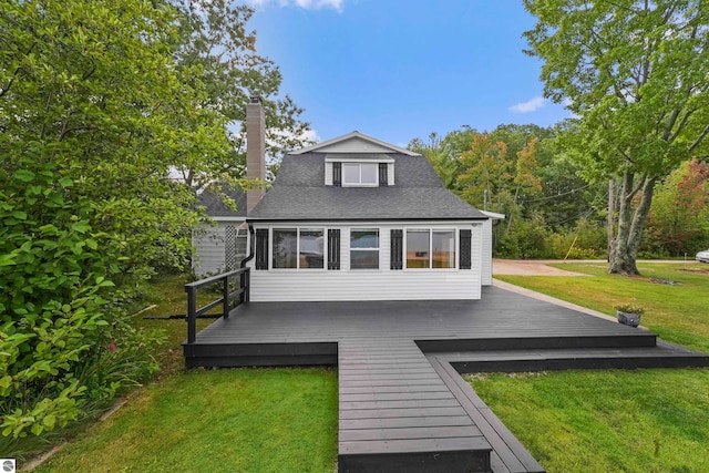 back of house featuring a deck and a yard