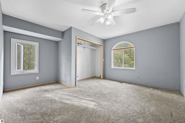 7504 W Dakota Trl, Lake City, MI 49663 - unfurnished bedroom featuring baseboards, a closet, a ceiling fan, and carpet floors
