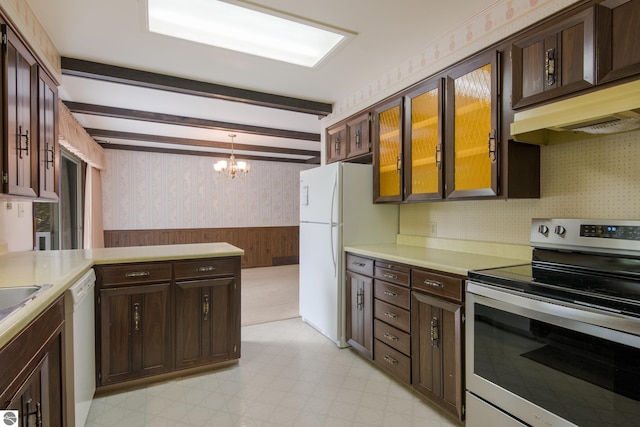 kitchen featuring light floors, white appliances, wainscoting, and wallpapered walls