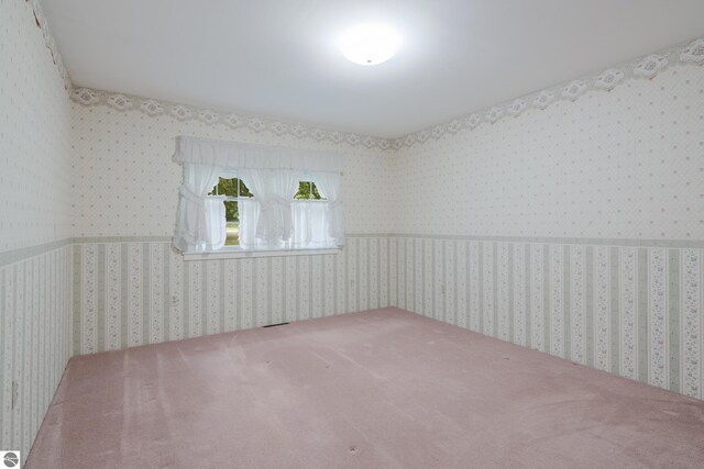 unfurnished room with carpet and ornamental molding