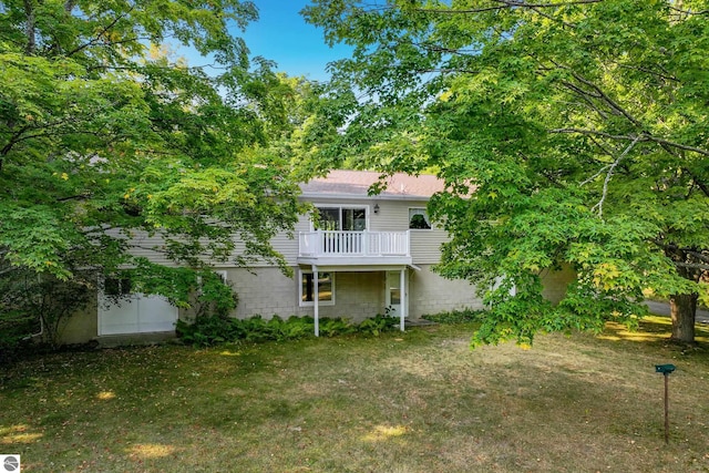 back of house featuring a deck and a lawn