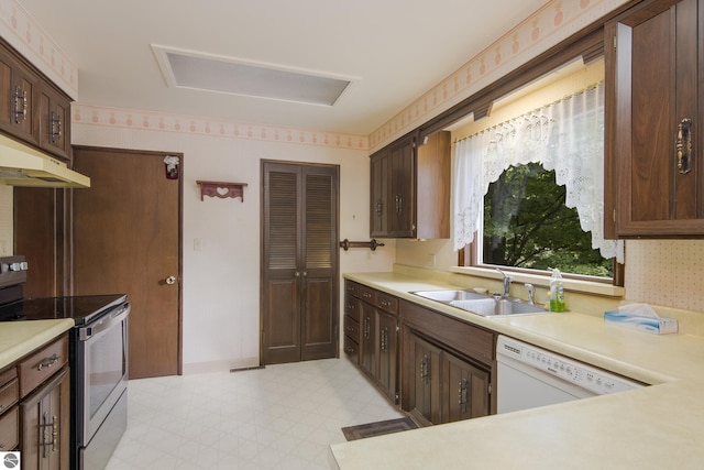 kitchen featuring white dishwasher, sink, dark brown cabinetry, and stainless steel electric range oven