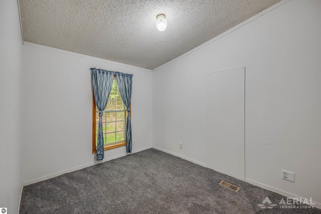 4949 N M-33, Rose City, MI 48654 - empty room with visible vents, ornamental molding, a textured ceiling, dark carpet, and baseboards