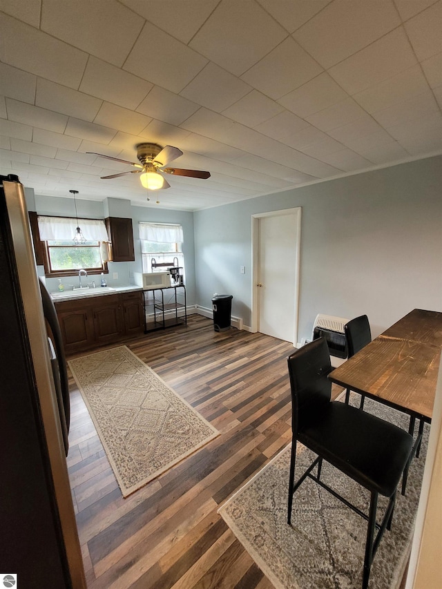 interior space with ceiling fan, light hardwood / wood-style floors, and sink