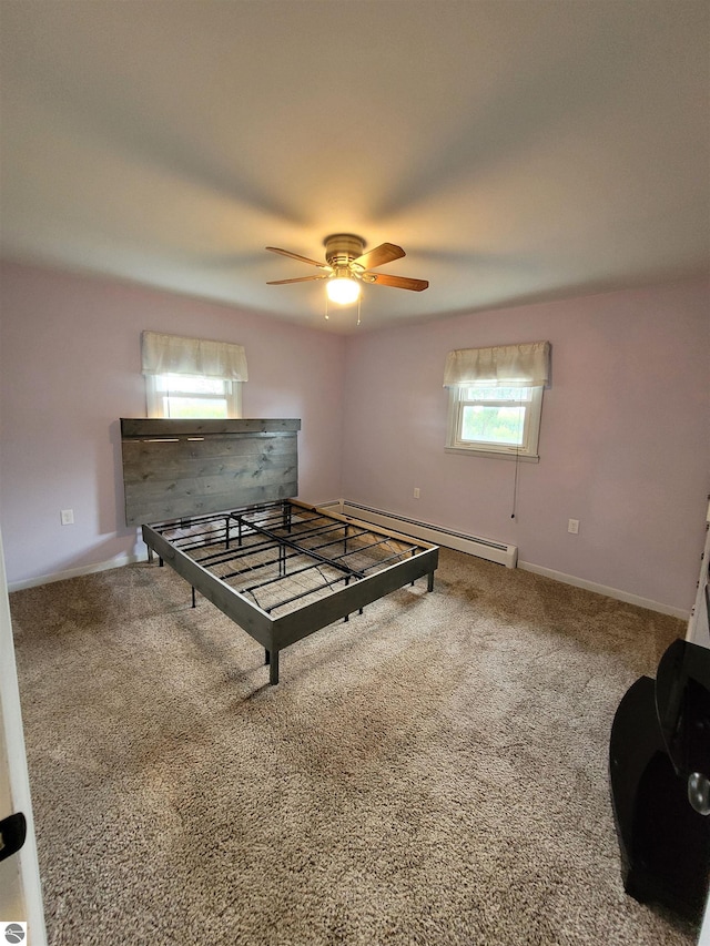 unfurnished bedroom featuring a baseboard radiator, ceiling fan, and carpet flooring