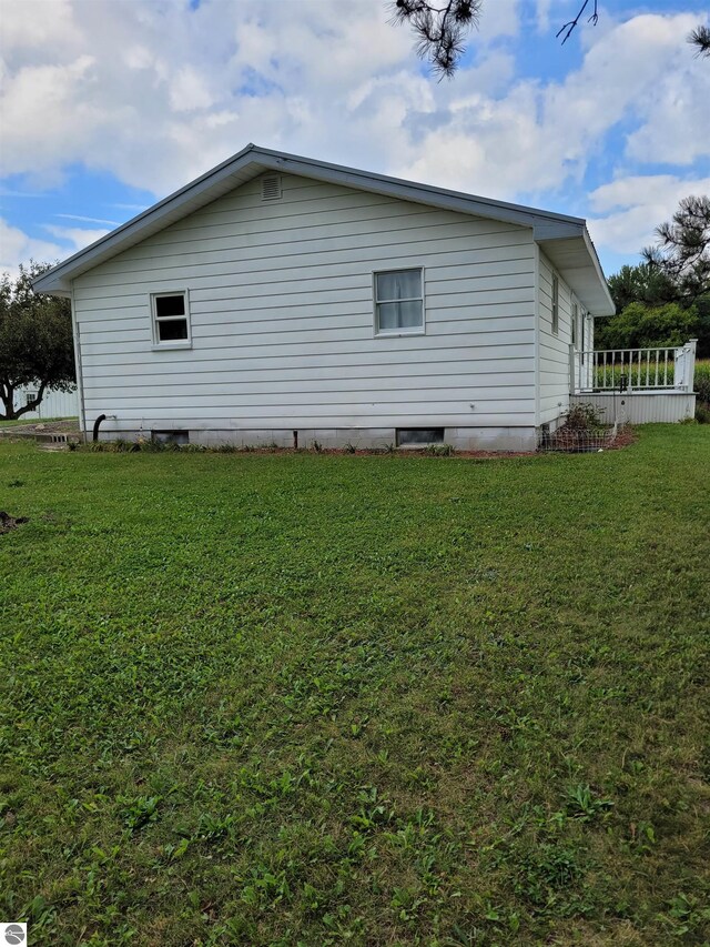 view of property exterior with a yard