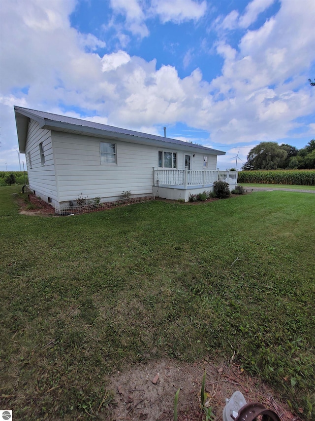 rear view of house featuring a yard