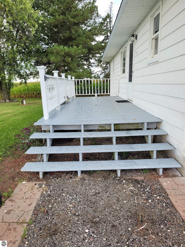 wooden terrace with a lawn