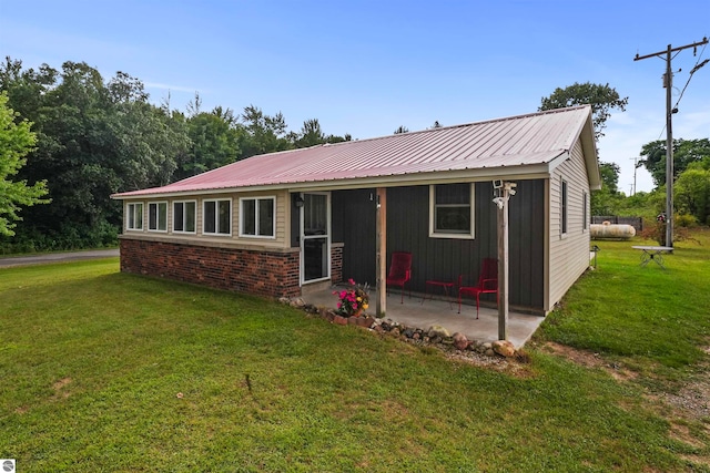 view of front facade with a front lawn and a patio