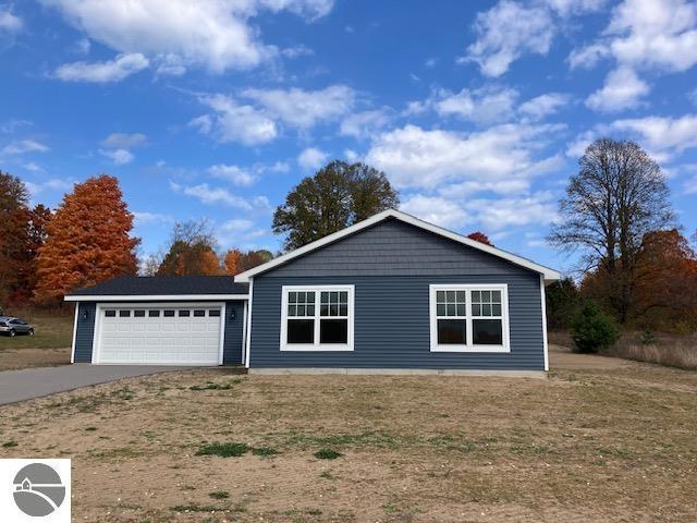 view of front of home featuring a garage and concrete driveway