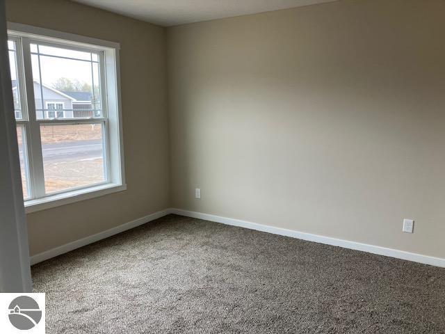 9217 Kingsfield Dr Unit 9, Kingsley, MI 49649 - spare room featuring carpet floors and baseboards
