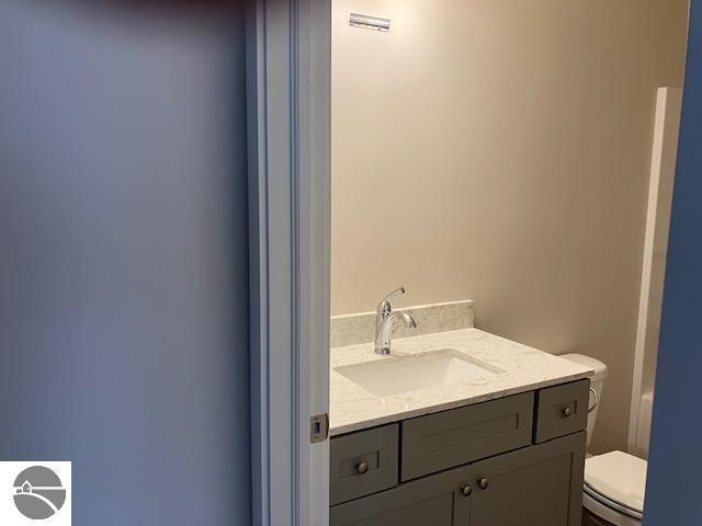 9217 Kingsfield Dr Unit 9, Kingsley, MI 49649 - bathroom featuring toilet and vanity