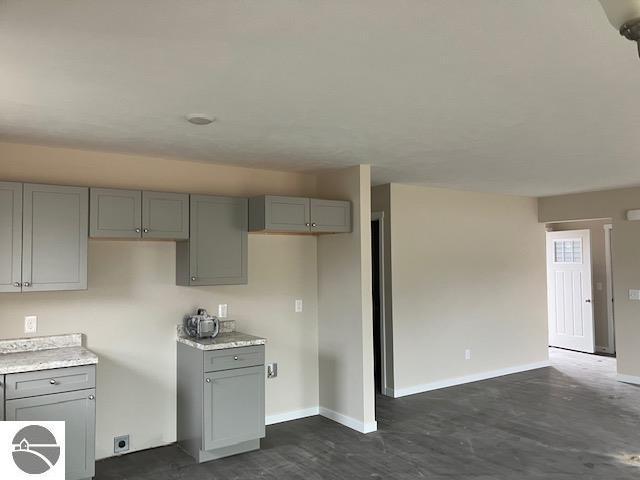 kitchen with baseboards and gray cabinets