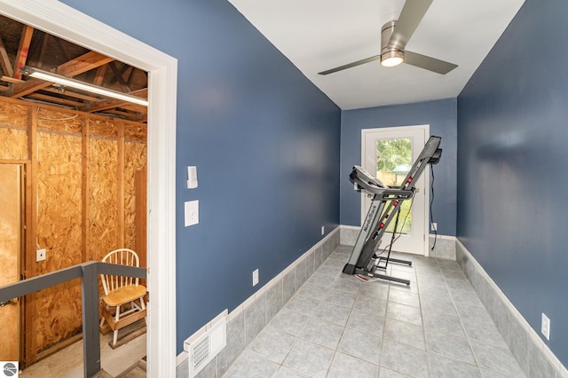 exercise room featuring ceiling fan, baseboards, visible vents, and tile patterned floors