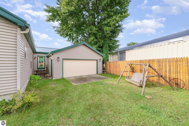 view of yard with a garage and fence