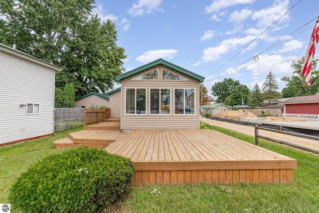 exterior space with a yard, fence, and a wooden deck