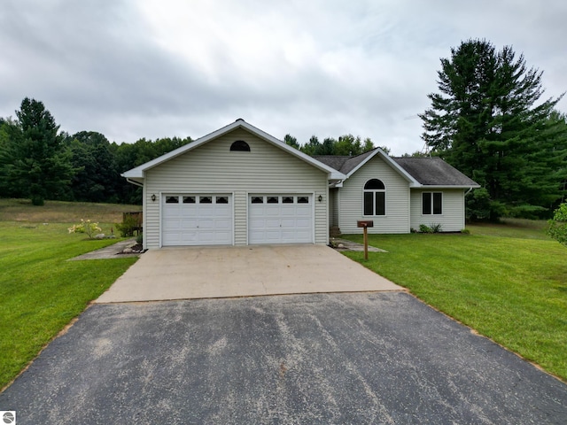 single story home featuring a garage and a front yard