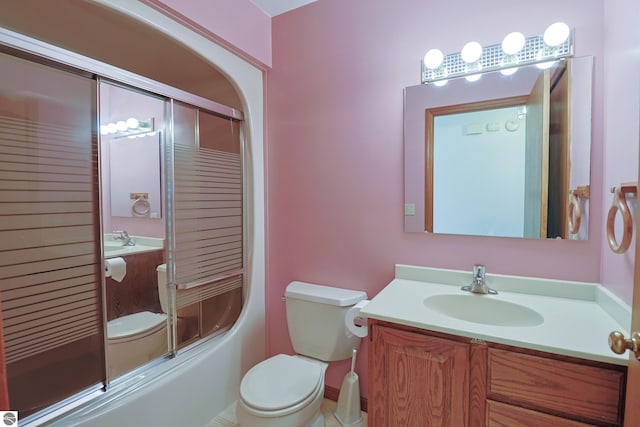 bathroom with toilet, vanity, and bath / shower combo with glass door