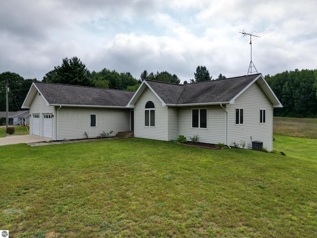 single story home featuring a garage and a front lawn