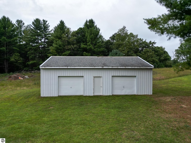 view of outdoor structure featuring a yard and a garage