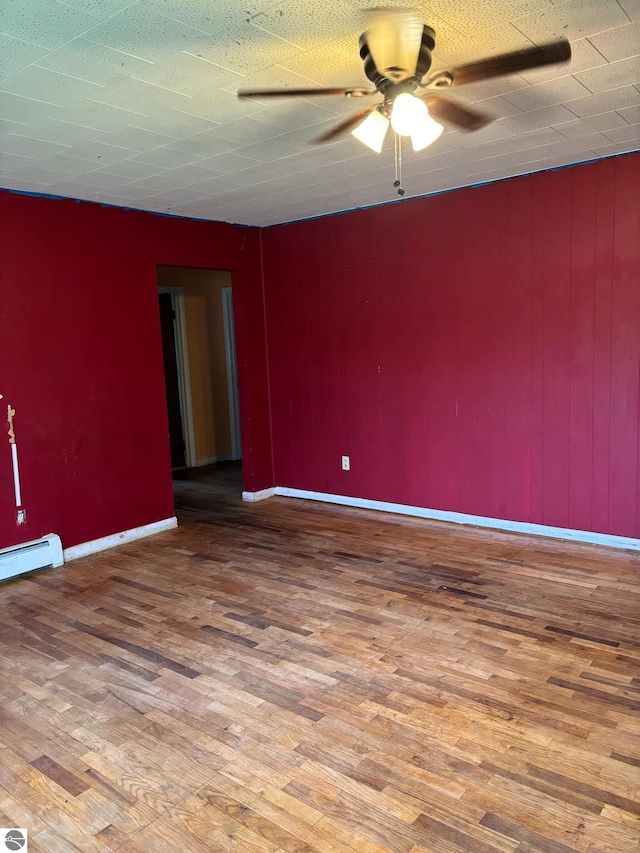 spare room featuring ceiling fan and hardwood / wood-style flooring