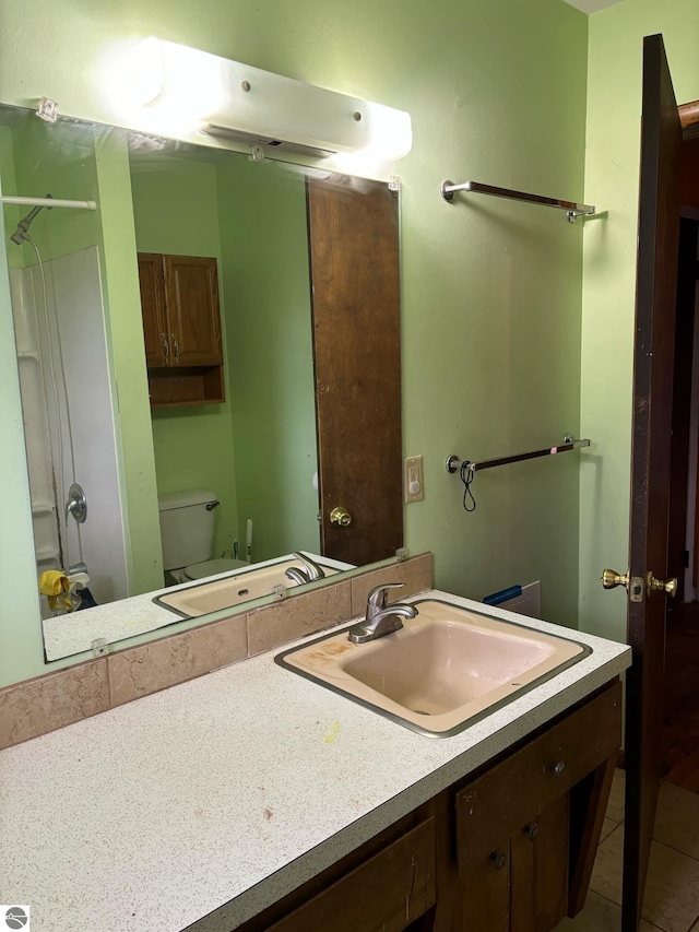 full bathroom featuring tile patterned flooring, vanity, toilet, and tub / shower combination