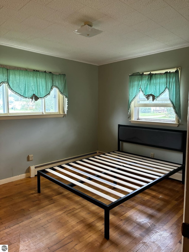 unfurnished bedroom featuring wood-type flooring and a textured ceiling