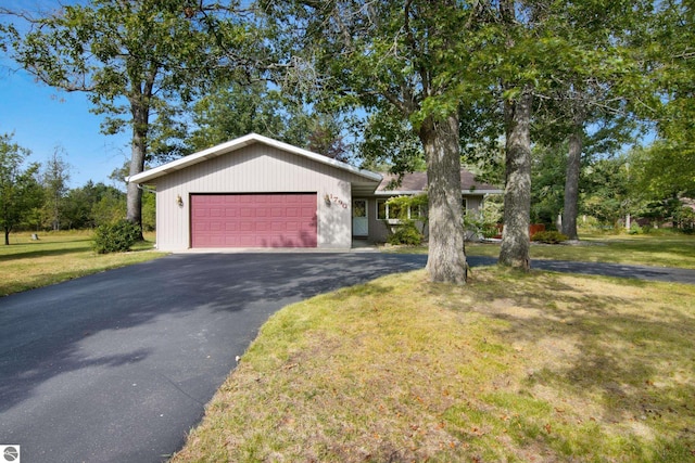 ranch-style house with a garage and a front lawn