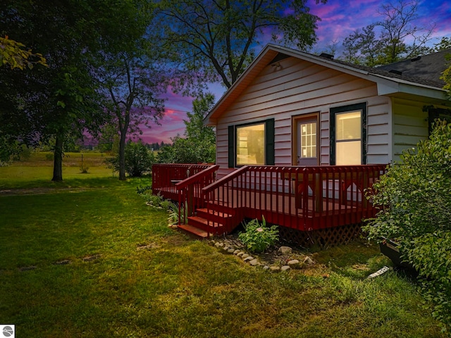 view of front of house with a yard and a wooden deck