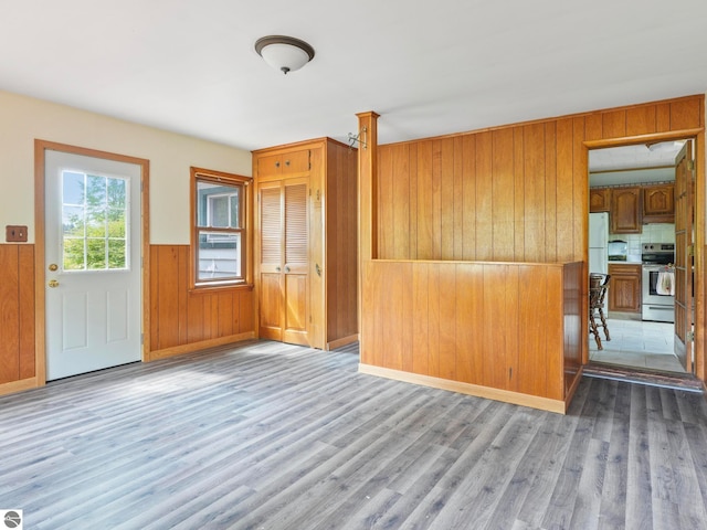 interior space featuring wood walls and hardwood / wood-style flooring