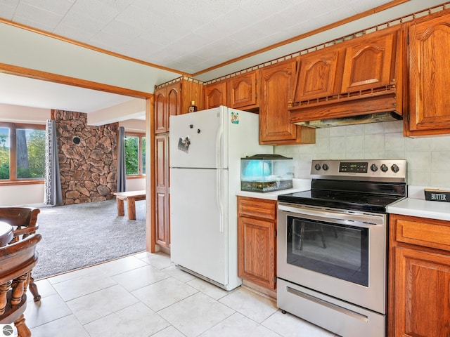 kitchen with white fridge, stainless steel electric range oven, light carpet, tasteful backsplash, and custom exhaust hood