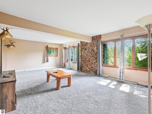 unfurnished living room with beamed ceiling and carpet flooring