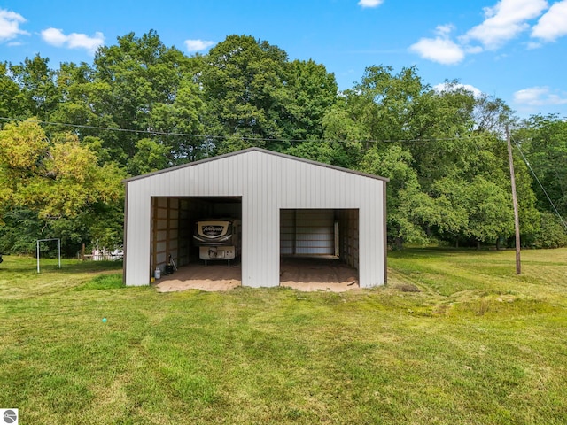 view of outdoor structure featuring a garage and a lawn