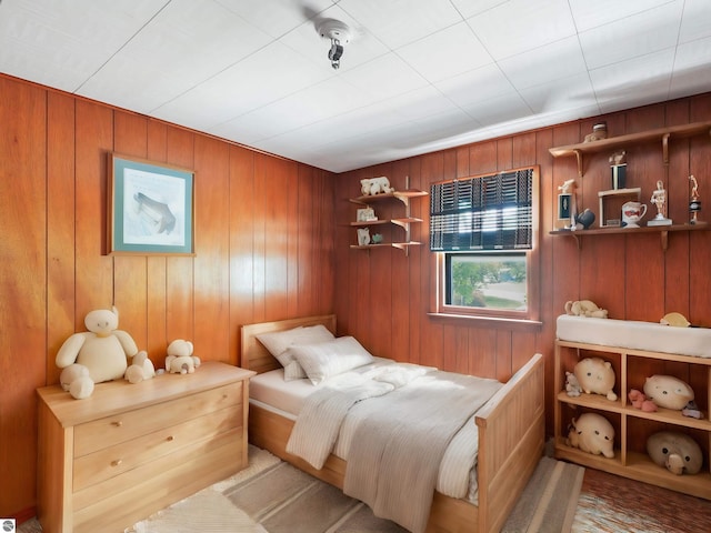 bedroom with wooden walls