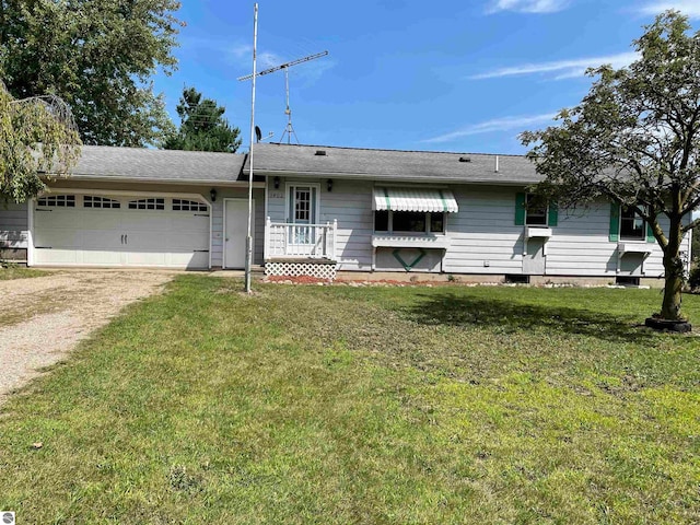 ranch-style house featuring a garage and a front lawn