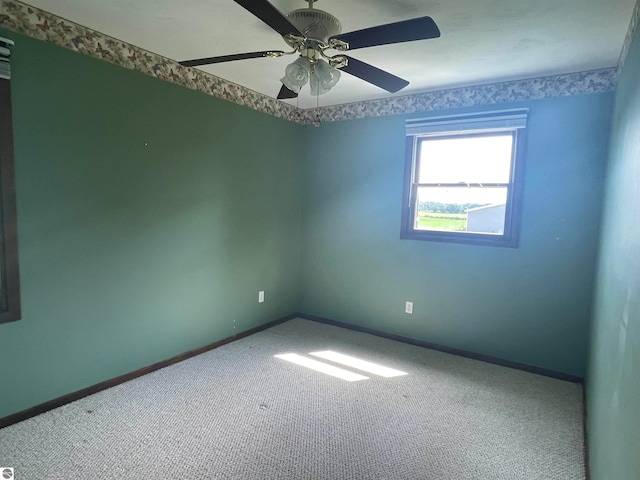 carpeted empty room with ceiling fan