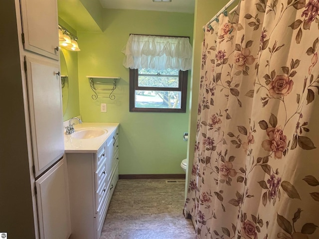 bathroom with vanity, toilet, and a shower with shower curtain