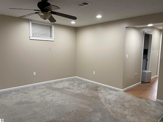 carpeted spare room featuring ceiling fan