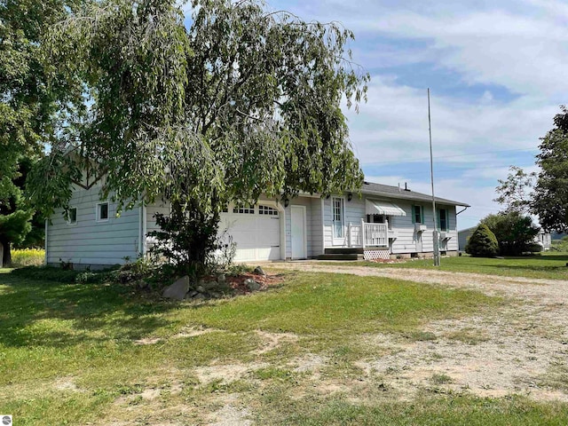 view of front of property with a front lawn and a garage