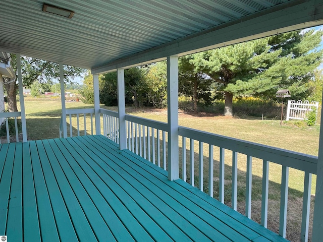 wooden terrace featuring a lawn