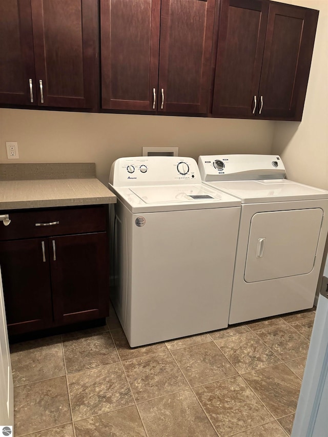 laundry area featuring cabinets and washing machine and clothes dryer