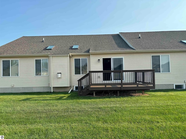 rear view of property featuring a yard and a deck