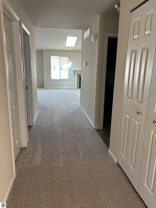 corridor with light colored carpet