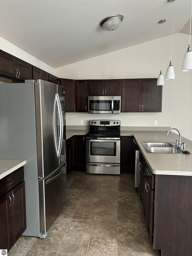 kitchen with vaulted ceiling, decorative light fixtures, dark brown cabinets, appliances with stainless steel finishes, and sink