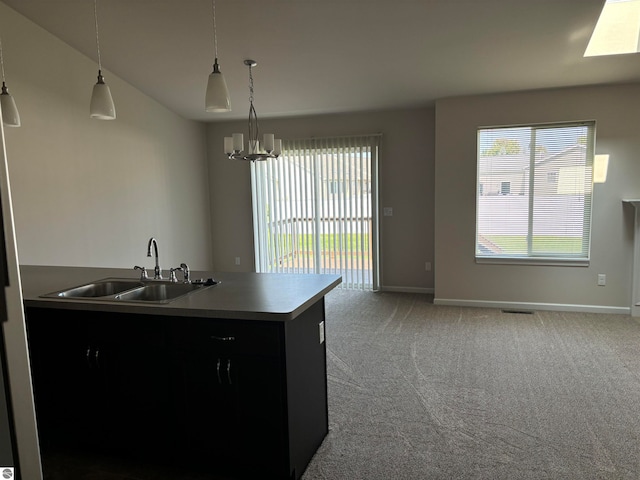 kitchen featuring a chandelier, sink, hanging light fixtures, vaulted ceiling, and carpet floors