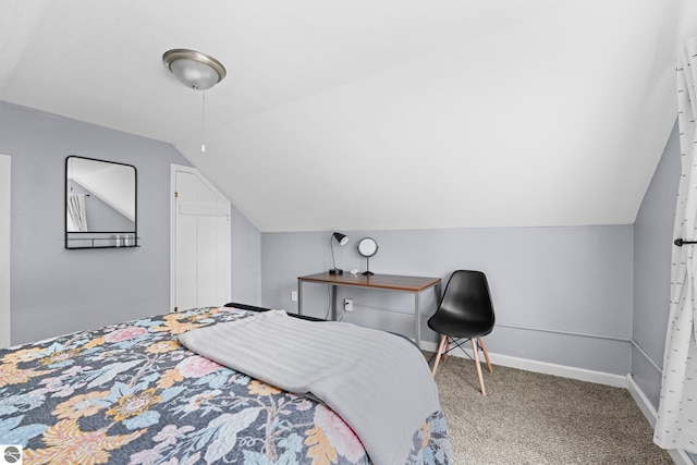 bedroom featuring lofted ceiling and carpet flooring